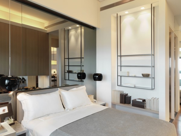 Mirror above headboard in bedroom