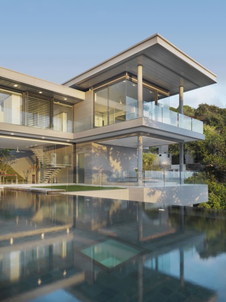 Multiple story modern home with swimming pool out front