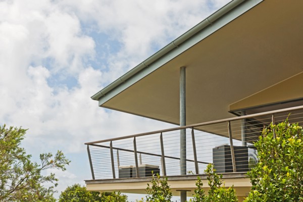Balcony of residential building against cloudy sky