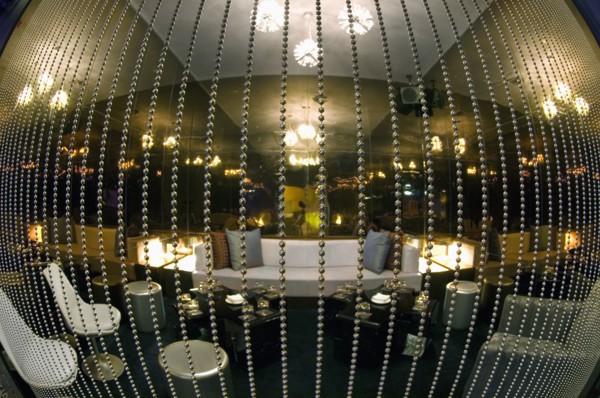 Fisheye view of lounge area behind beaded curtain in nightclub