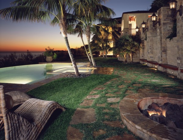 Backyard of modern home with pool at sunset