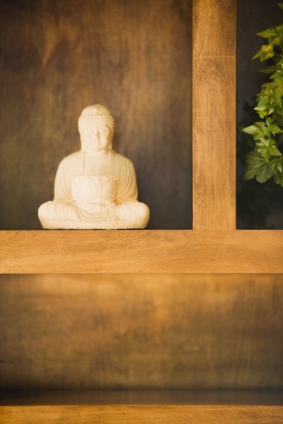 Statue of Buddha on Shelf