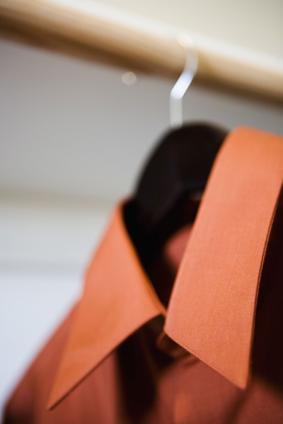 Red Collared Dress Shirt Hanging in Closet