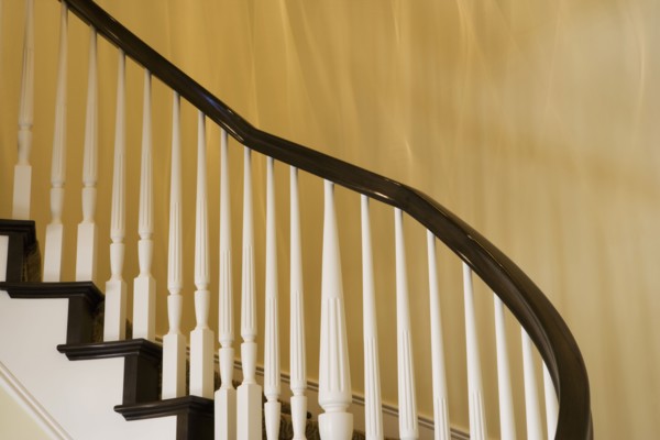 Contemporary Stairway with White Railings and Dark Wood Bannister