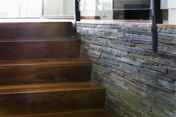 Modern Hardwood  Stairway with Stone Wall