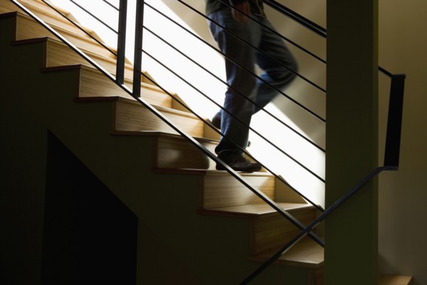 Moody Detail of Person Descending Modern Stairs