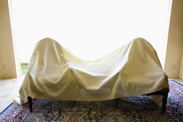 Two chairs covered in a white sheet