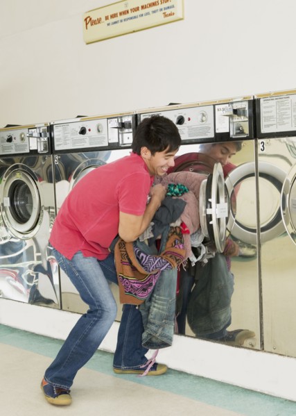 Asian man in laundromat