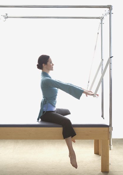 Woman stretching on exercise equipment