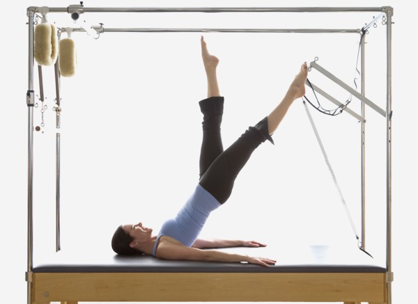 Woman stretching on exercise equipment