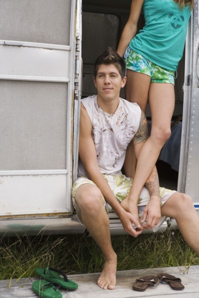 Multi-ethnic couple in doorway of camper