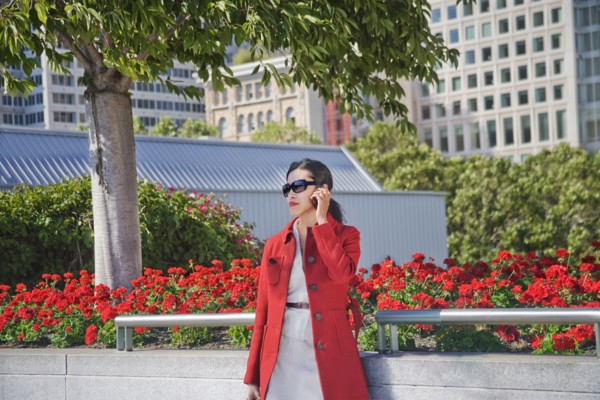 Asian businesswoman talking on cell phone outdoors
