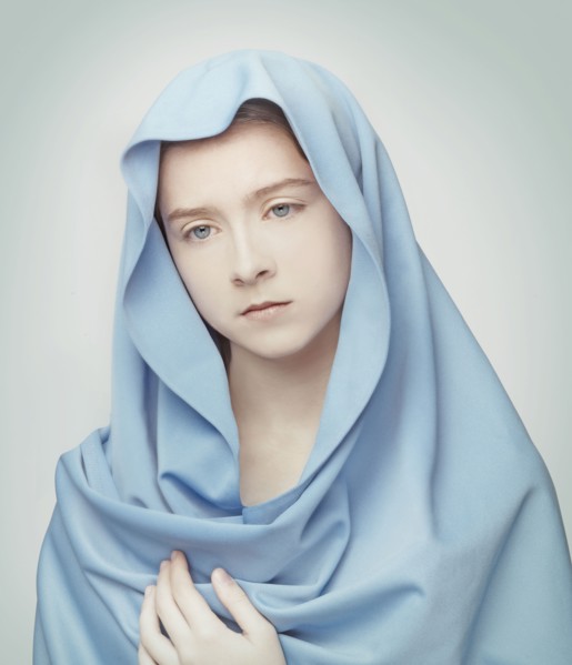 Caucasian girl wrapped in blanket