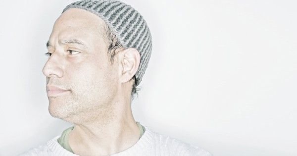Mixed race man wearing cap