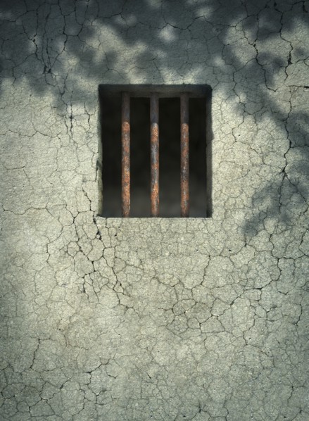 Bars on window of dilapidated wall