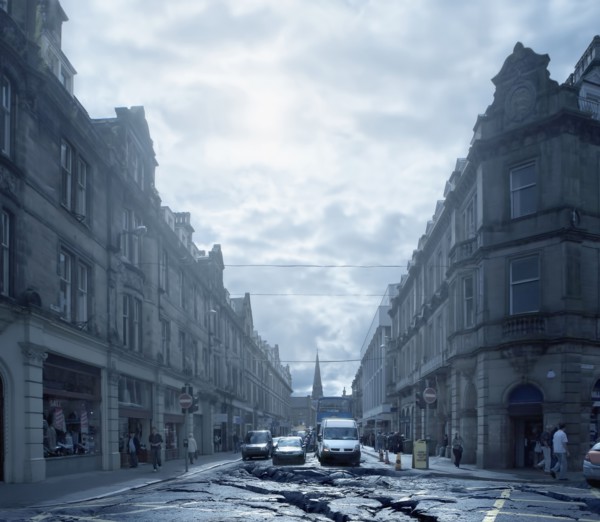 Cars driving on cracked urban pavement