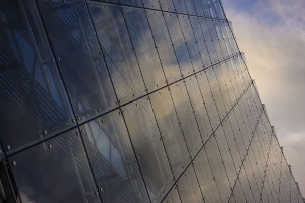 Close up of clouds reflected in windows of highrise