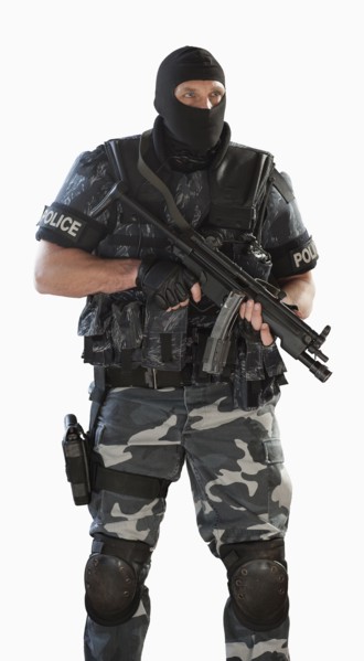 Police officer in gear holding assault rifle