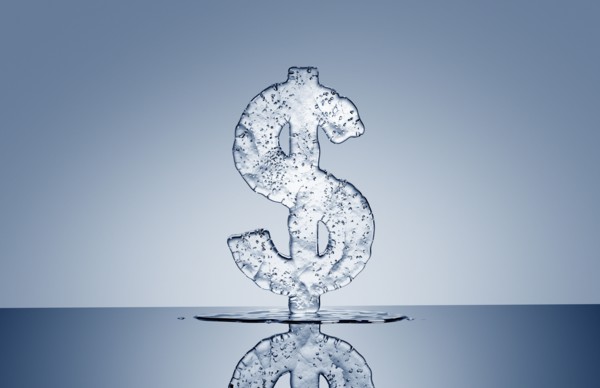 Puddle under melting ice dollar symbol
