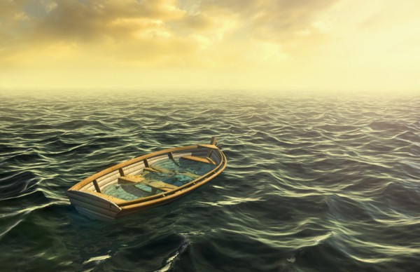 Abandoned sinking rowboat in ocean