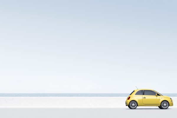 Yellow car near ocean