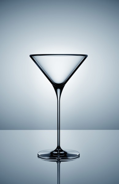 Empty martini glass on gray background