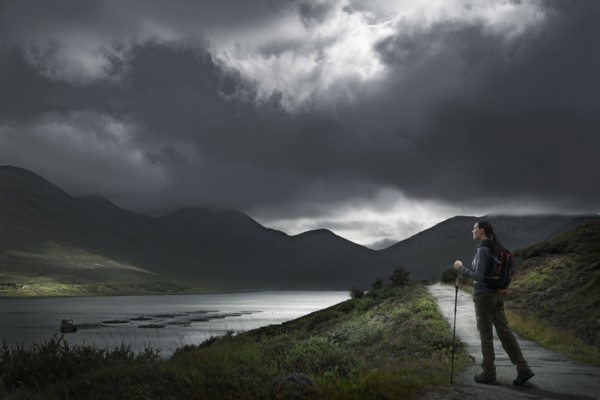 Caucasian woman hiking on path near river