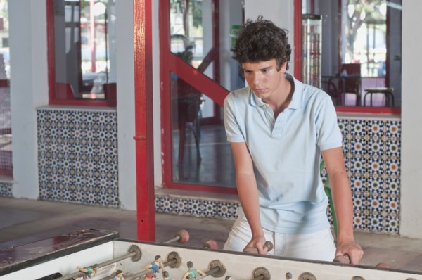 Hispanic teenager playing foosball