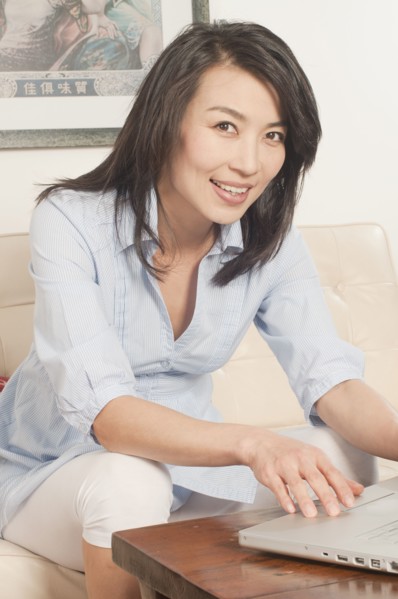 Korean woman using laptop in living room