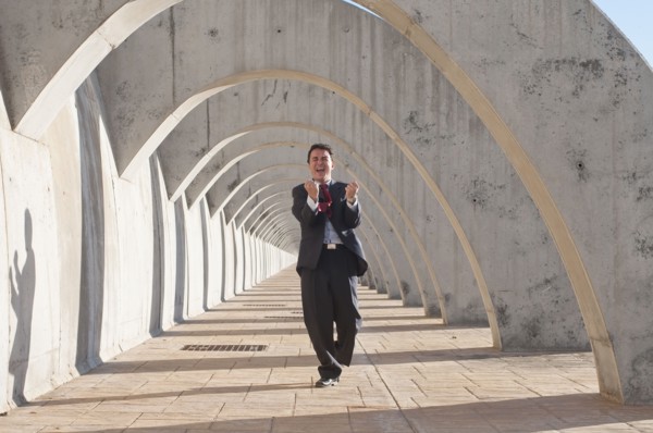 Hispanic businessman cheering at success