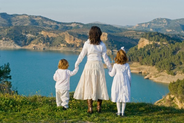Spain Malaga mother and children looking at lake rear view