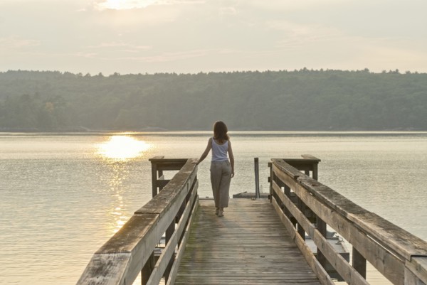 woman looking out to sea from jetty