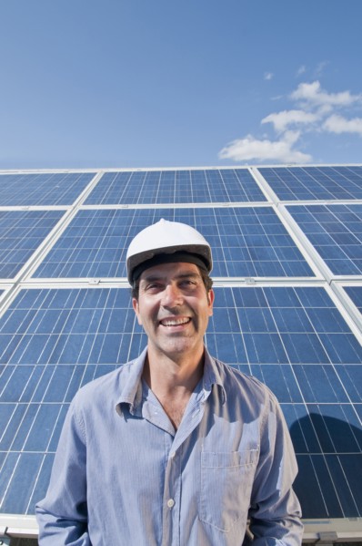 engineer in front of solar panels