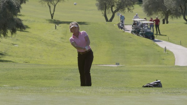 Caucasian woman playing golf on course