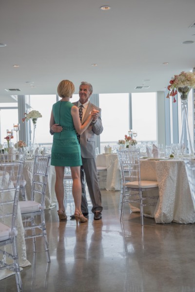 Caucasian couple dancing in empty restaurant