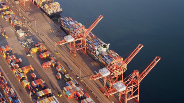 Aerial view of containers and cranes in industrial shipyard