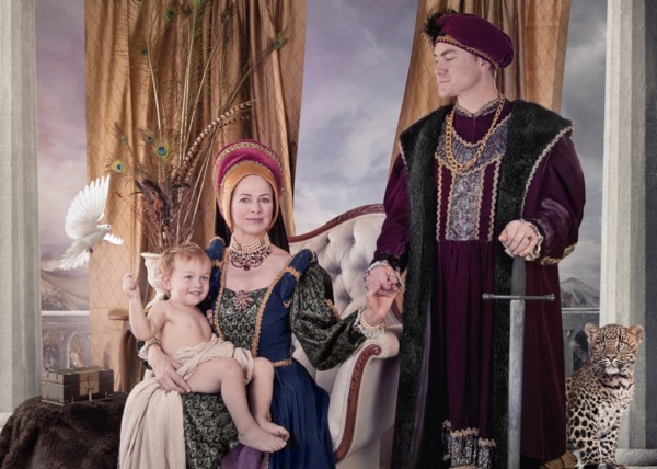 Medieval couple and child posing in living room