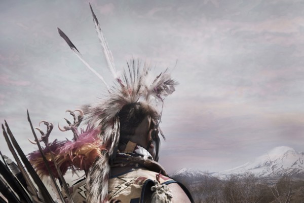 Hunter wearing traditional native headdress