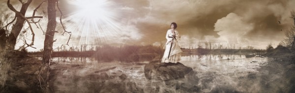 Caucasian woman standing on rock in remote lake