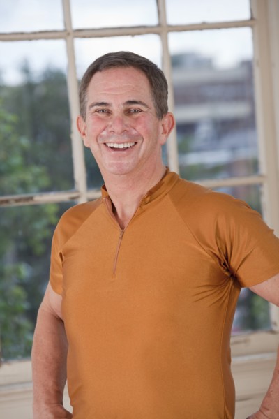 Smiling Caucasian mean standing near window