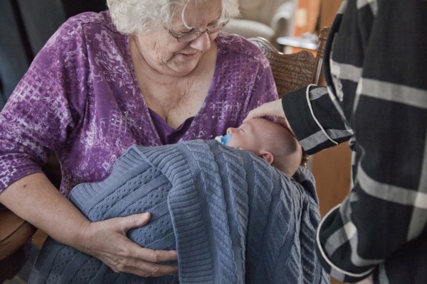 Caucasian grandmother holding baby grandson