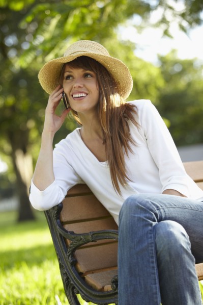 Mixed race woman talking on cell phone outdoors