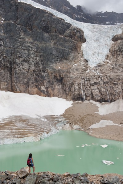 Hispanic woman hiking hear glacial lake
