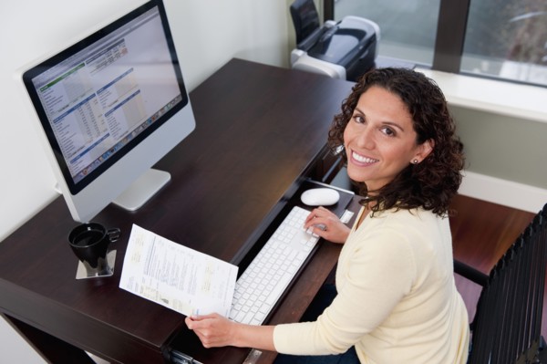 Hispanic woman paying bills on computer