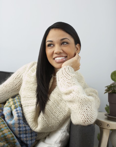 Smiling woman sitting on sofa