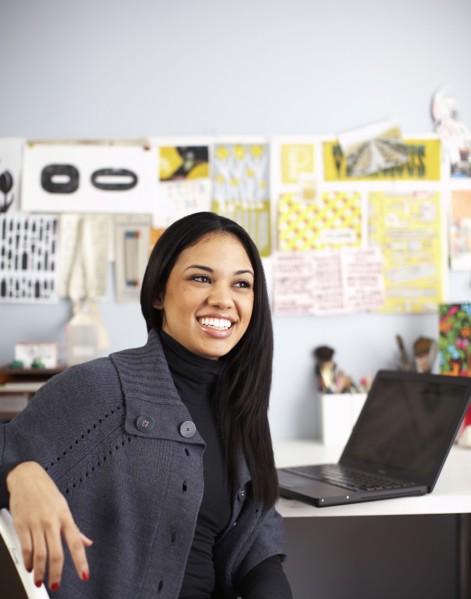 Smiling businesswoman sitting at desk
