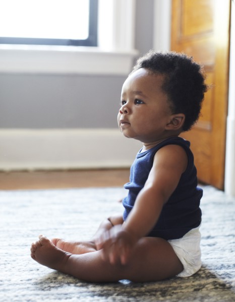 African American baby sitting on floor