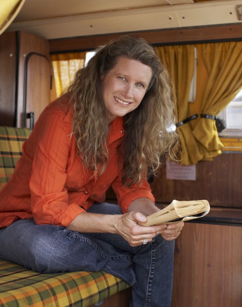Caucasian woman reading book in camper
