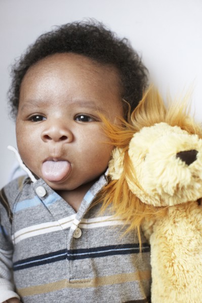 African American baby sticking out tongue