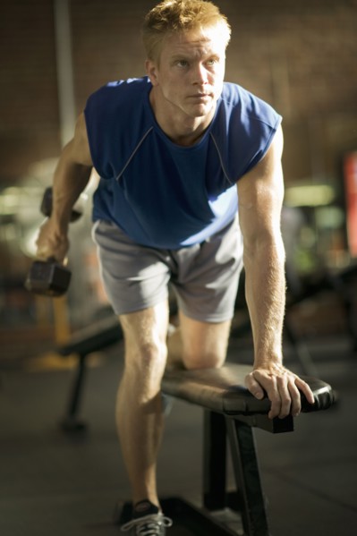 Man lifting weights in health club